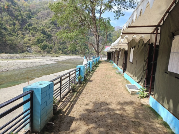 Camping tents in Mohan Chatti adventure zone near Rishikesh surrounded by forest hills