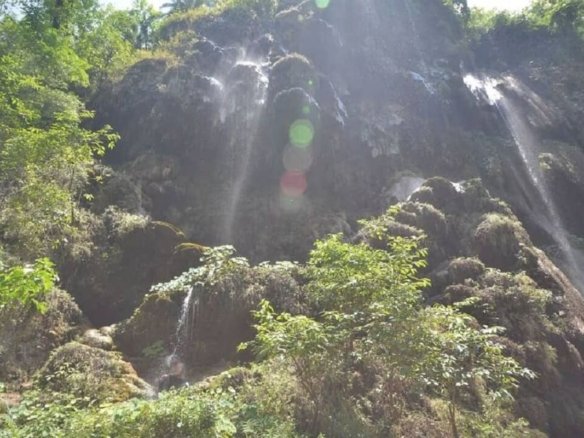 Patna Waterfall near Rishikesh surrounded by forest trail and flowing mountain stream