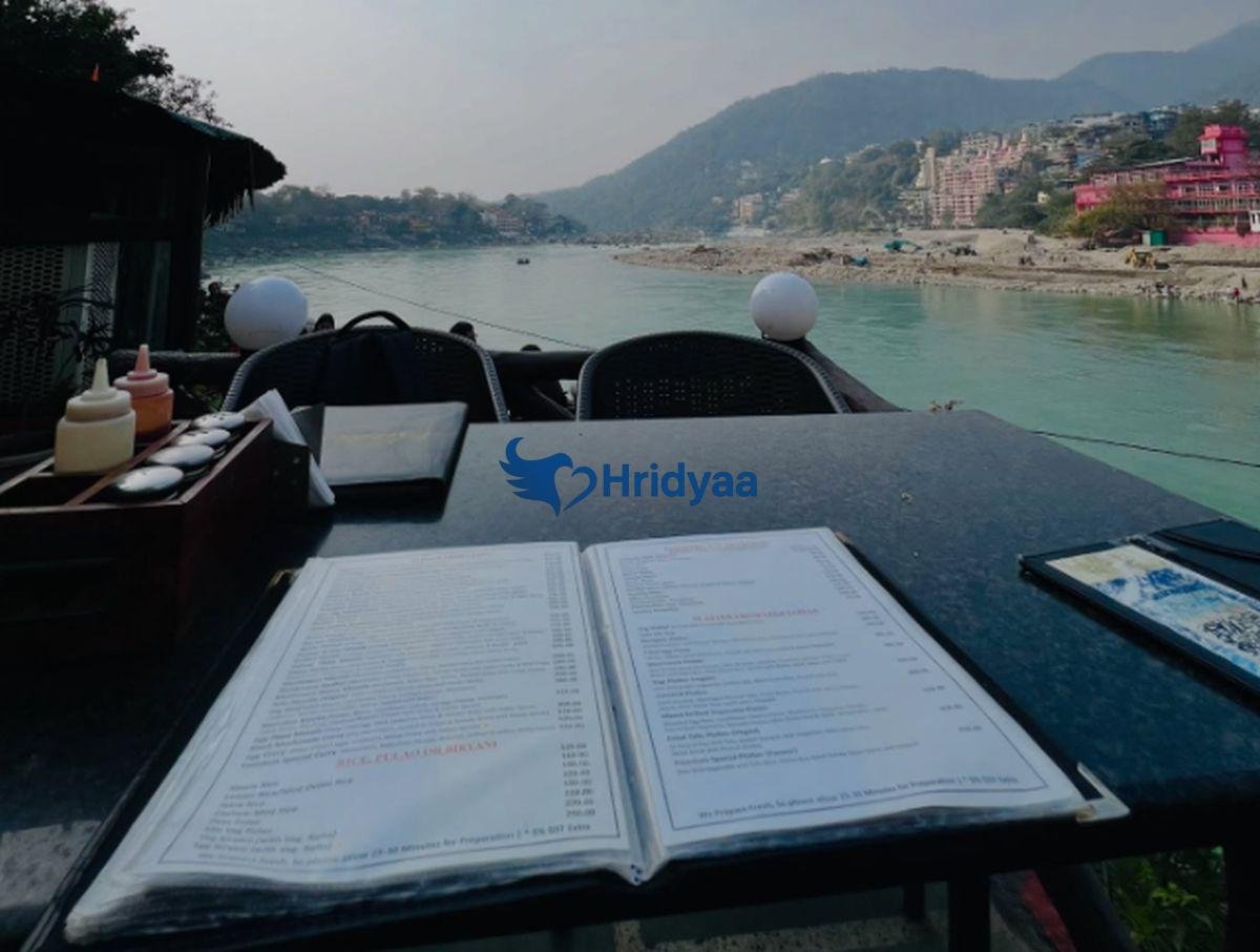 sunset view from rooftop cafe in rishikesh with golden sky and ganga river